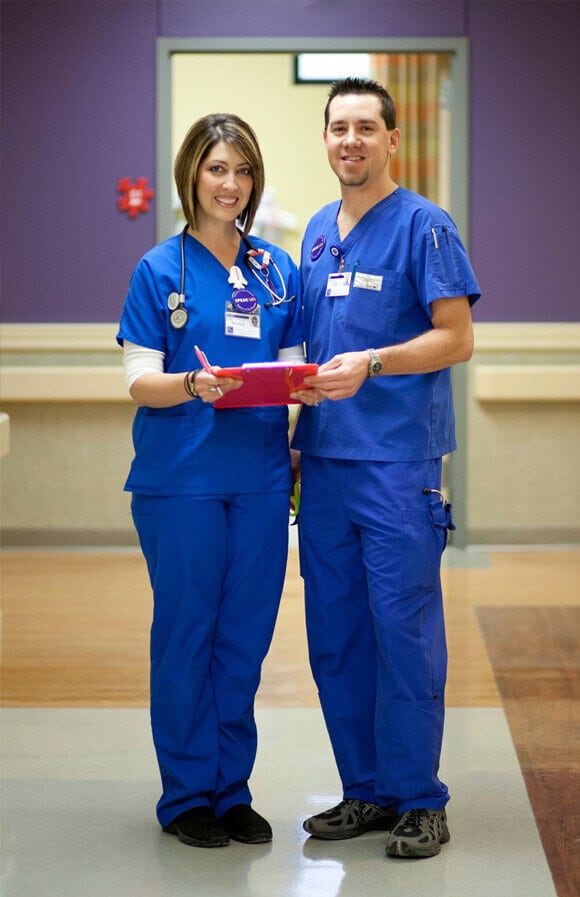 Nurses Career Ladder - Two Smiling Nurses with Clipboard